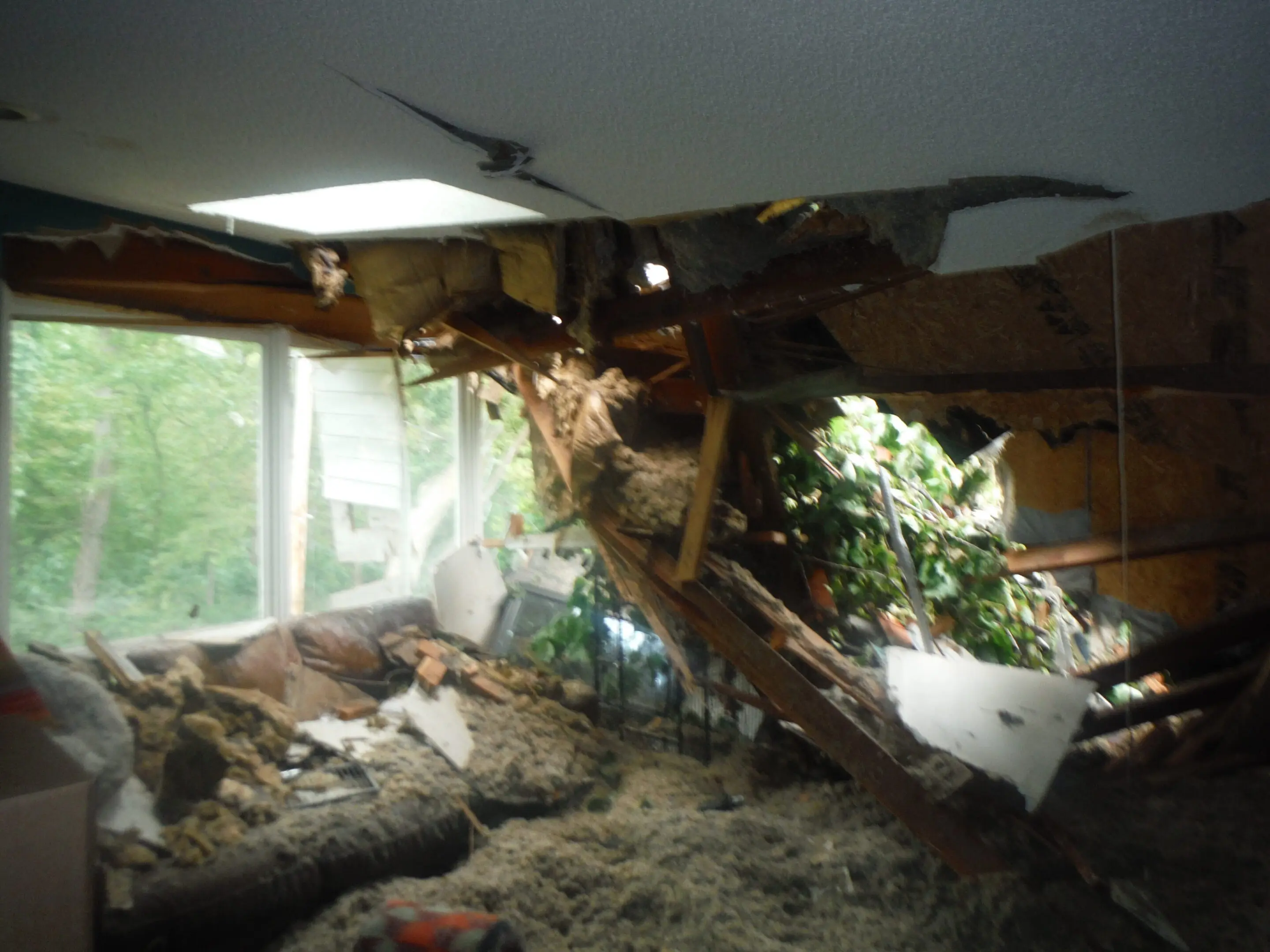 Collapsed ceiling and debris in damaged room.