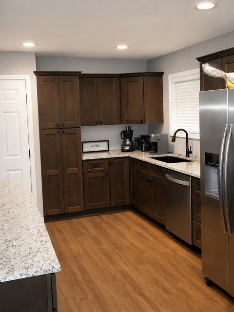 Modern kitchen with wooden cabinets and appliances.