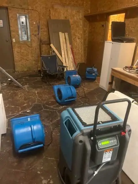Industrial fans drying a wet floor.