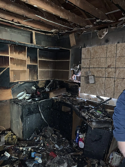 Burnt kitchen with severe fire damage.