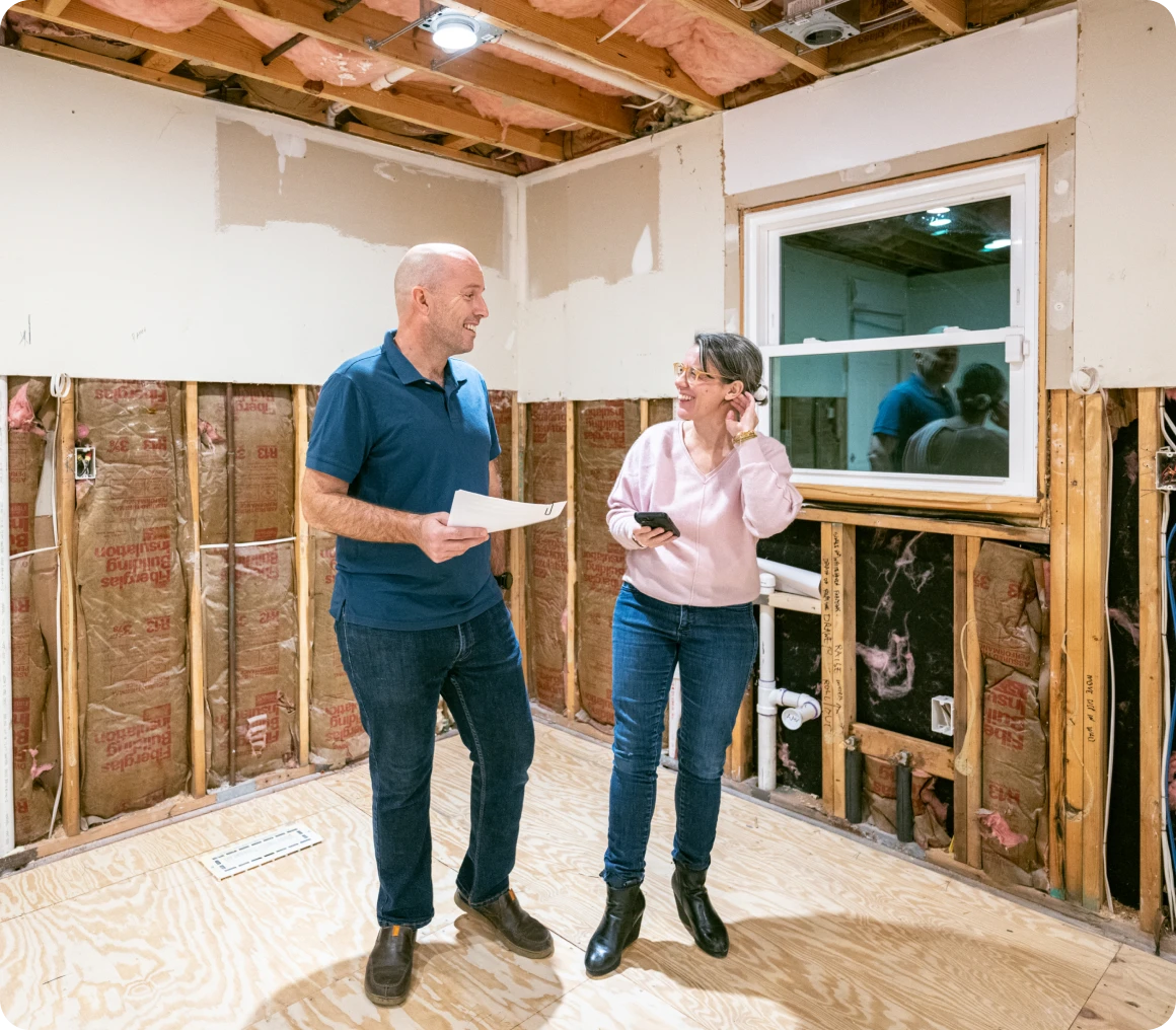 Two people discussing home renovation plans.